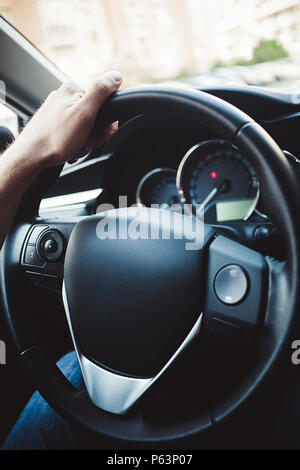 Male arms holding leathern rudder of car Stock Photo - Alamy