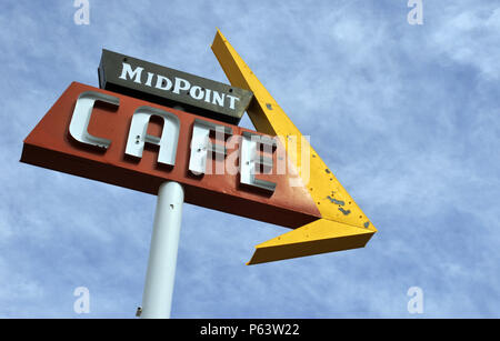 A sign advertising the Midpoint Cafe stands along Route 66 in Adrian, Texas, marking the halfway point of the legendary American road. Stock Photo