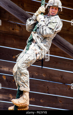 Participants from team three climb Jacob’s Ladder, the first obstacle ...