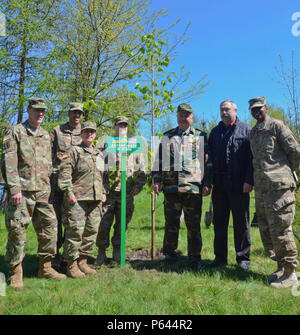 U.S. Army civil affairs Soldiers along with Soldiers with the Joint Multinational Training Group-Ukraine and Ukrainian locals pose for a photo Apr. 28, 2016 during the planting of a “peace tree” at the National Park Headquarters in Ivano-Frankove, Ukraine. The tree planted was a linden tree, which traditionally is symbolic for long life and good health in demonstration of the strong bond that JMTG-U has with the local community. (U.S. Army photo by Staff Sgt. Adriana M. Diaz-Brown, 10th Press Camp Headquarters) Stock Photo