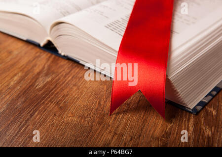 large book with bookmark on a wood background Stock Photo