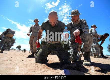 A Spanish Legion soldier recovers with the help of a U.S. Air Force master sergeant after being exposed to Oleoresin Capsicum 'pepper' spray during a non-lethal weapons class as a part of AFRICAN LION 16 at Tifnit, Kingdom of Morocco, April 23, 2016. Of the 11 nations participating in the annual exercise, a group of U.S. military members, Royal Moroccan armed forces members, Spanish Legion soldiers and Royal Netherlands army soldiers lived in field conditions and participated in daily familiarization with other nation’s tactics to improve interoperability. (U.S. Air Force photo by Senior Airma Stock Photo