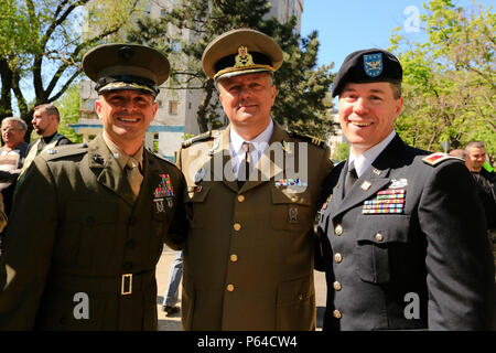U.S. Marine Corps Lt. Col. Justin J. Ansel, left, commanding officer of the Black Sea Rotational Force, Romanian Land Force Col. Paul Moglan, center, deputy of the commander of the 9th Mechanized Brigade 'Marasesti', and U.S. Army Col. Lee M. Ellis, right, director of Black Sea Area Support Team Romania Bulgaria, pose for a photo together during the celebration of Land Forces Day in Constanta, Romania, April 22, 2016. This holiday is celebrated in garrisons throughout Romania to honor the sacrifice of the forefathers of the Romanian Army and to evoke the combat traditions of military units. (U Stock Photo