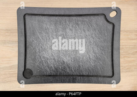 grey carved stripped used meat cutting board on wooden backgournd Stock Photo