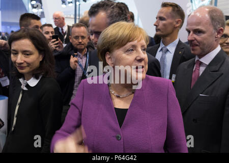 BERLIN, GERMANY - APRIL 25, 2018: Visit of Chancellor of Germany Angela Merkel to the stand of Liebherr Group. Exhibition ILA Berlin Air Show 2018. Stock Photo