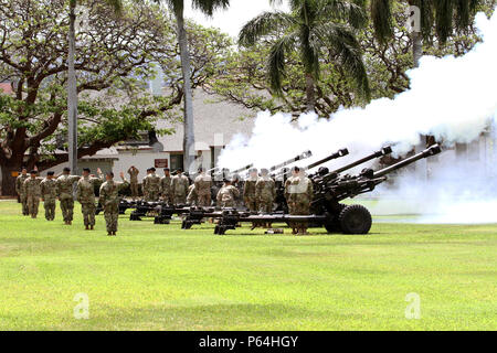 Soldiers with 3rd Brigade, 7th Field Artillery, 25th Infantry Division Salute Battery, honors the in-coming and out-going U.S. Army Pacific Commanding General with a gun salute during the beginning of the change of command ceremony between, Gen. Vincent K. Brooks and Gen. Robert B. Brown. (U.S. Army photo by Staff Sgt. Kyle J. Richardson) Stock Photo