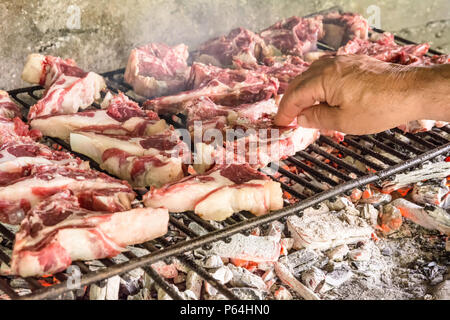 grilled goat chops. Roast meat on a barbecue Typical brick barbecue in Sardinia, Italy. Selective focus Stock Photo