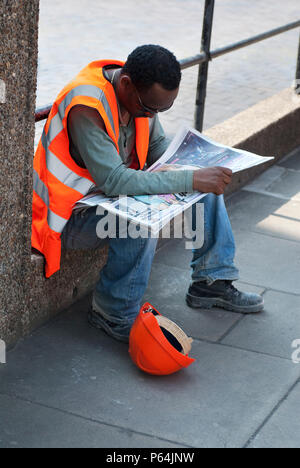 Construction site worker having a break, London, UK Stock Photo