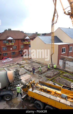 Cement truck pouring concrete, Groundwork for house building. Trench reinforced with steel. Stock Photo