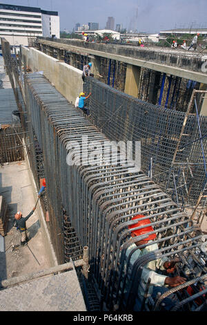 Fixing steel reinforcement for in situ concrete structure, Bangkok, Thailand. Foundations for a waste water processing plant. Stock Photo