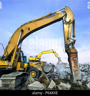 Hydraulic breaker attachment on Caterpillar excavator with Komatsu wheeled loader and excavator in background. John F Kennedy International Airport. N Stock Photo