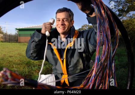 A telecommunications network designer with telephone cables at an exchange, UK Stock Photo