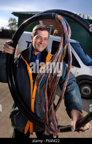 A telecommunications network designer with telephone cables at an exchange, UK Stock Photo
