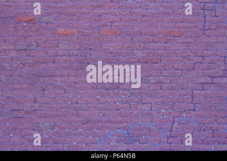 Brick wall background featuring old and distressed red and pink color clay bricks in traditional running bond pattern Stock Photo