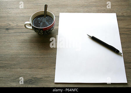 Coffee, blank paper and pen on wooden desk Stock Photo