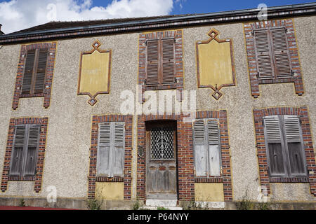 Old abandoned stone and brick facade of an old house in a small village in France with character Stock Photo