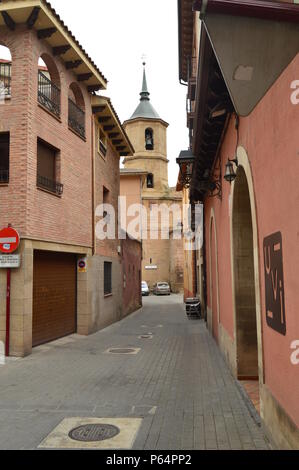 View Of The Bell Tower Of La Cruz Church In The Plaza De Navarra De Najera From One Of Its Narrow Streets. Architecture, Travel, History. December 26, Stock Photo