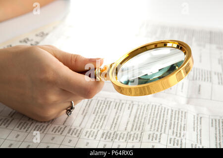 worker examines a magnifying glass text close up Stock Photo