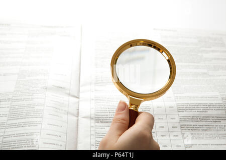 worker examines a magnifying glass text close up Stock Photo