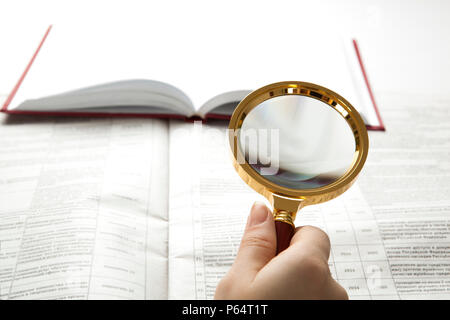 worker examines a magnifying glass text close up Stock Photo