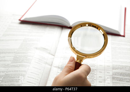 worker examines a magnifying glass text close up Stock Photo