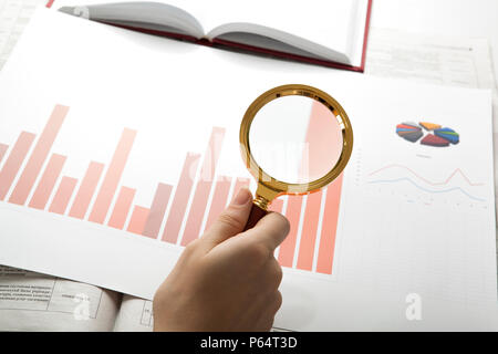 worker examines a magnifying glass text close up Stock Photo