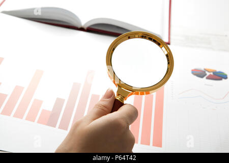 worker examines a magnifying glass text close up Stock Photo