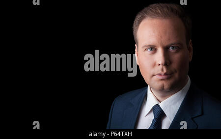 man in a suit and tie on a black background isolated Stock Photo