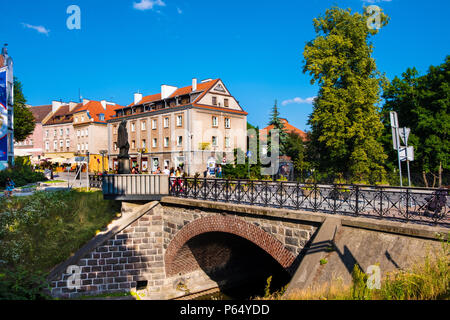 Olsztyn, Warmian-Masurian / Poland - 2018/06/16: Bridge over the Lyna river in historical quarter of Olsztyn old town Stock Photo