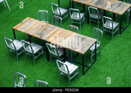 Desks and Chairs are arranged in order on the Lawn Stock Photo