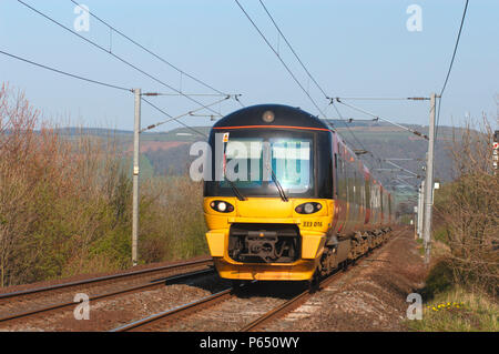 A Class 333 EMU trainset races through the Aire Valley with a Leeds - Skipton local service. April 2005. Stock Photo