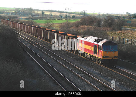 A Class 60 locomotive passes Melton Ross with empty iron ore wagons from Santon returning to Immingham Docks to collect a further load for the local s Stock Photo