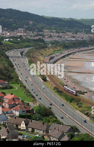 A First North Western Class 175 with a service from Holyhead runs alongside the A55 trunk road as it skirts the North Wales coast at Colwyn Bay. July  Stock Photo