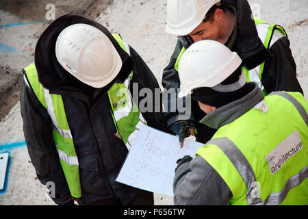 Construction workers discussing plans Stock Photo