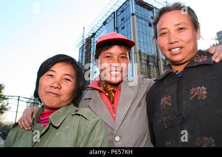 A trio of female migrant construction workers in Beijing. Stock Photo