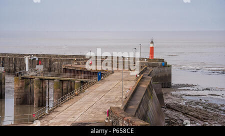 A view of a small red lighthouse on the jetty at Watchet in Somerset UK Stock Photo