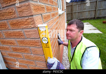Builder using a spirit level. Stock Photo