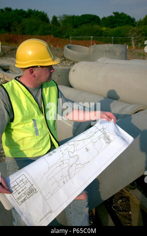Building technician checking plan on site Stock Photo