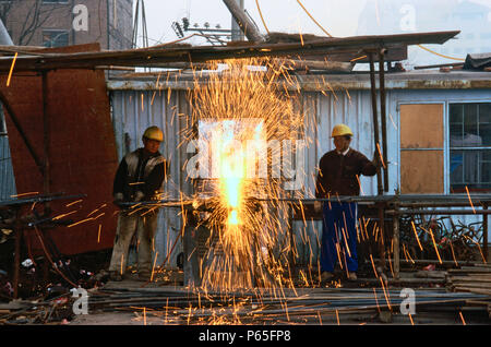 Construction workers welding on a building site, Beijing, China. Stock Photo