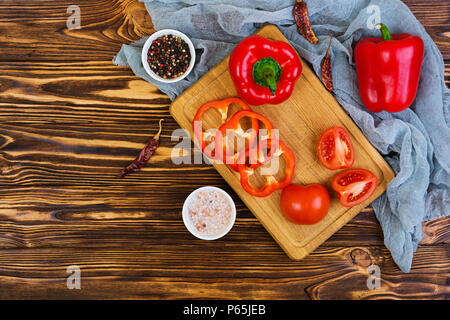 Pepper, tomato, salt, different spice on wooden background Stock Photo