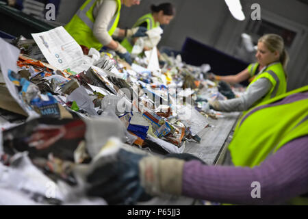 Recycling on conveyor belt being sorted at recycling centre Stock Photo