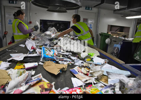 Recycling on conveyor belt being sorted at recycling centre Stock Photo