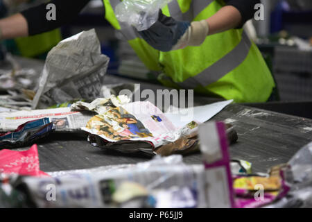 Recycling being sorted on conveyor belt Stock Photo