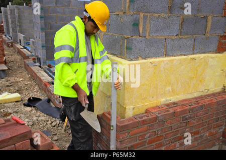 Bricklayer on a house building site, England, UK. Stock Photo