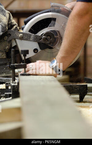 Man operating a circular saw Stock Photo