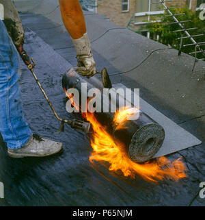 Flat roof bitumen on fire flames smoke safety risk Stock Photo - Alamy