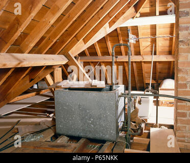 Central heating water tank in loft Stock Photo - Alamy