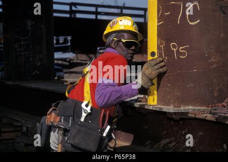 Female construction worker using level on bridge falsework Stock Photo
