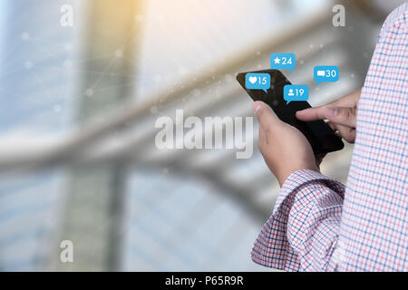 Young man using smart phone Social media and social network Marketing  concept People Connection Stock Photo