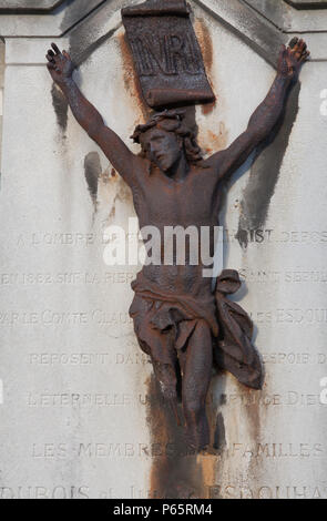Rusting statue of Jesus on a gravestone in Montmartre Cemetery in Paris, France Stock Photo